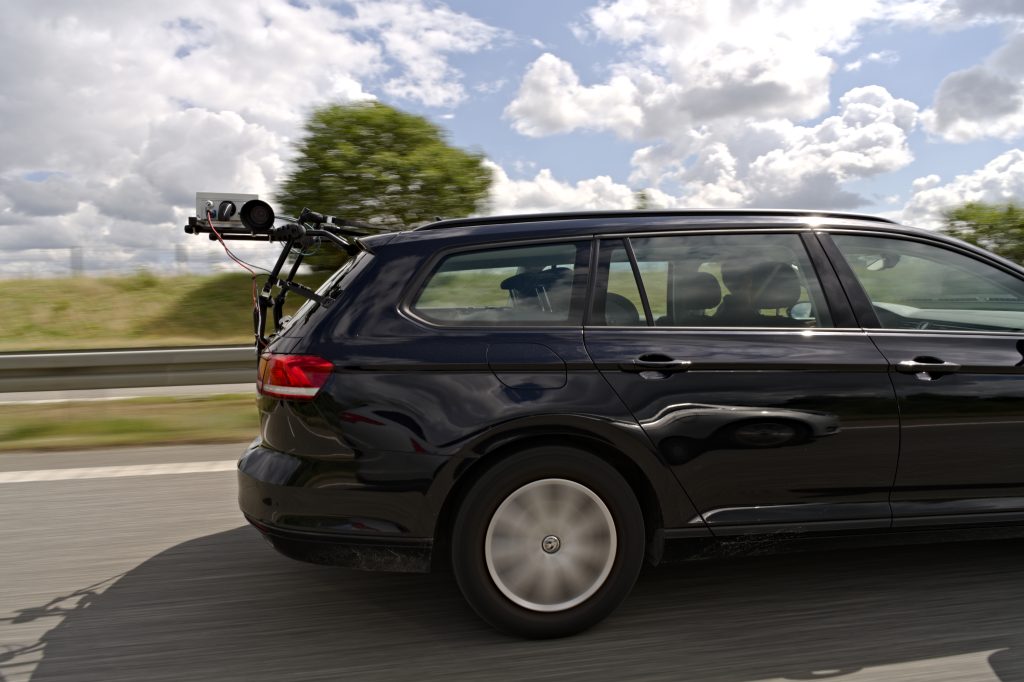 Car driving on a motorway with the CamAlien camera mounted on a rack at the back