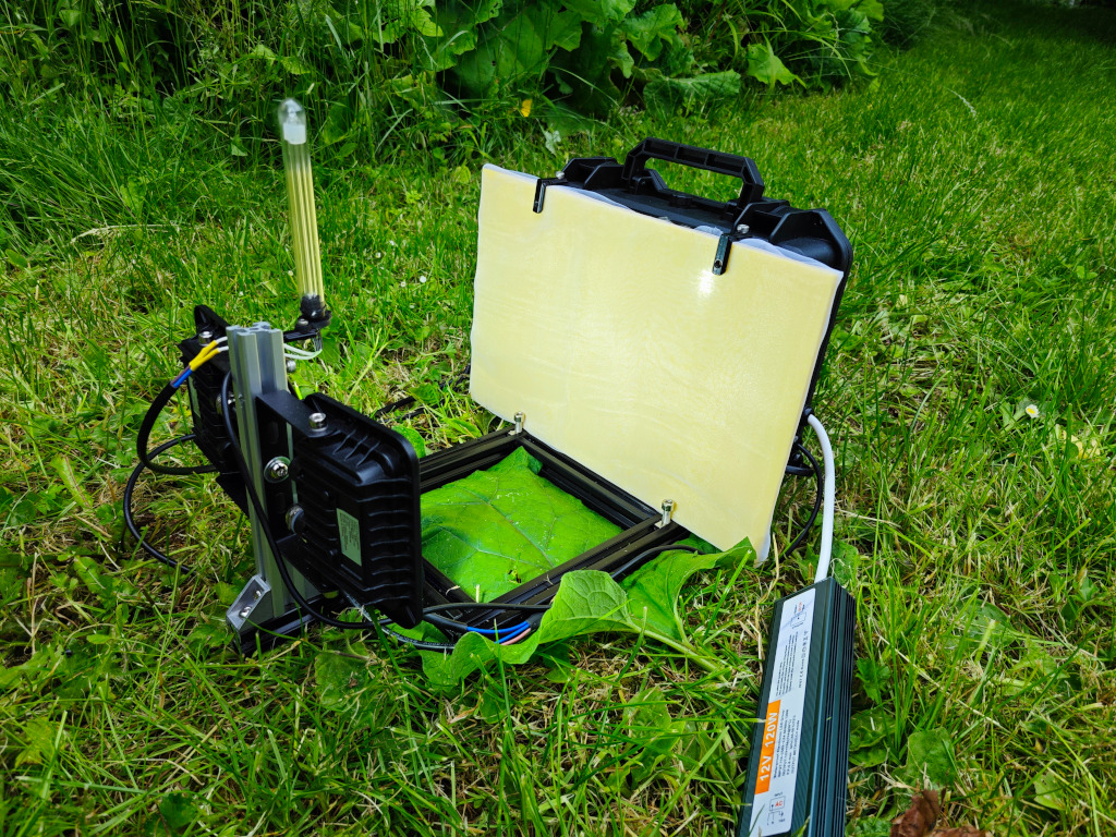 The mini camera moth trap mounted on a post